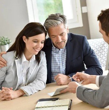 Real estate professional reviewing property information with a buyer in France