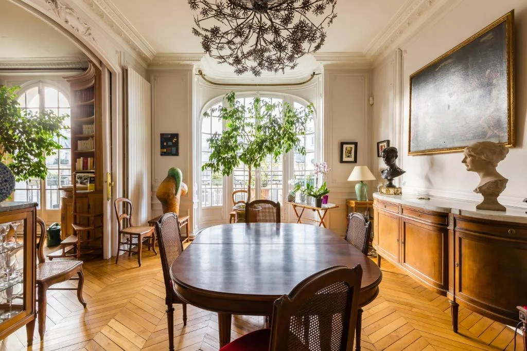 SHOKO examining carved woodwork detail in an exceptional Paris Haussmann apartment