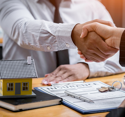 SHOKO shaking hands with American buyers after securing property viewings in France